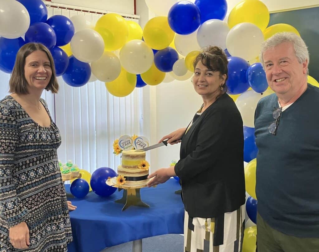 CEO Sam Ram cutting the cake at the launch of The Foster Care Charity with Barbara Bull Deputy CEO and Brian OConnell Trustee.