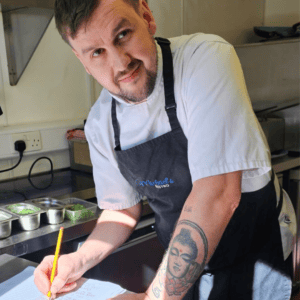 Chef Michael Carr, patron of The Foster Care Charity, preparing food in his bistro kitchen