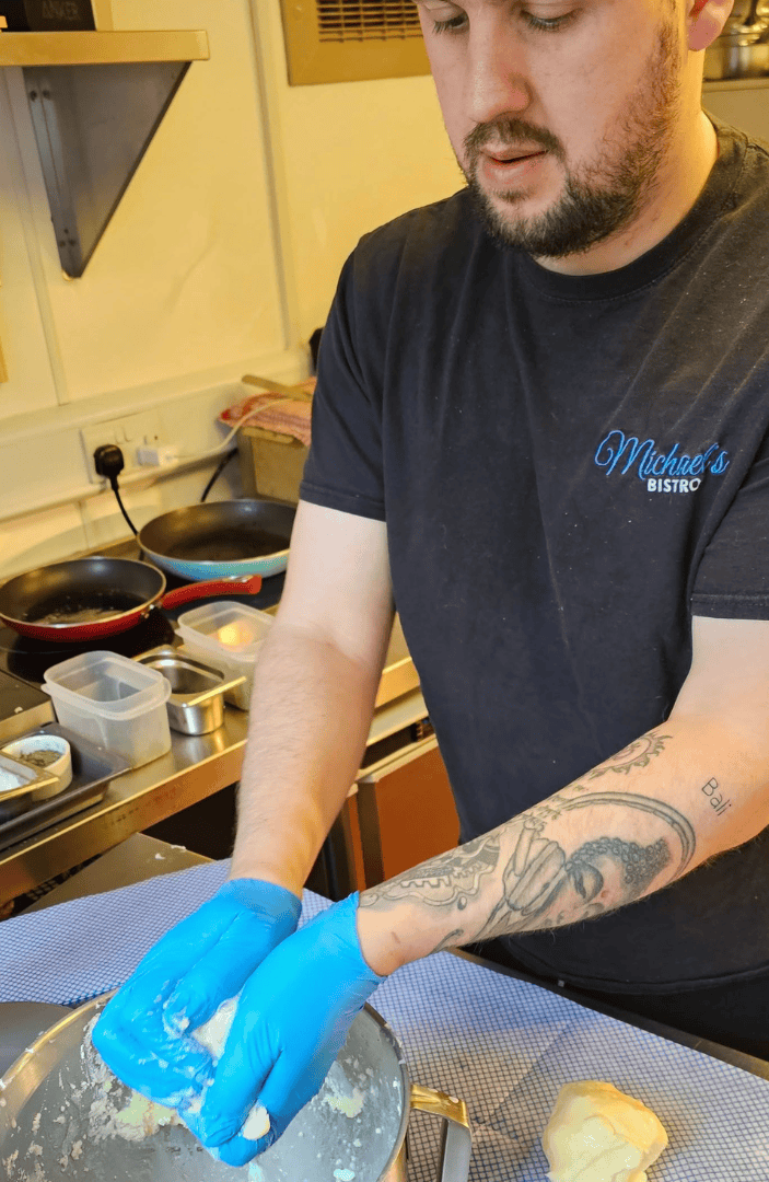Michael patron of The Foster Care Charity making dough in his bistro kitchen