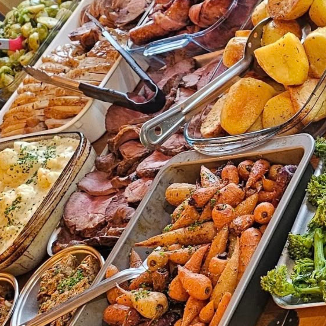 Chef Michael presents Sunday Roast food table